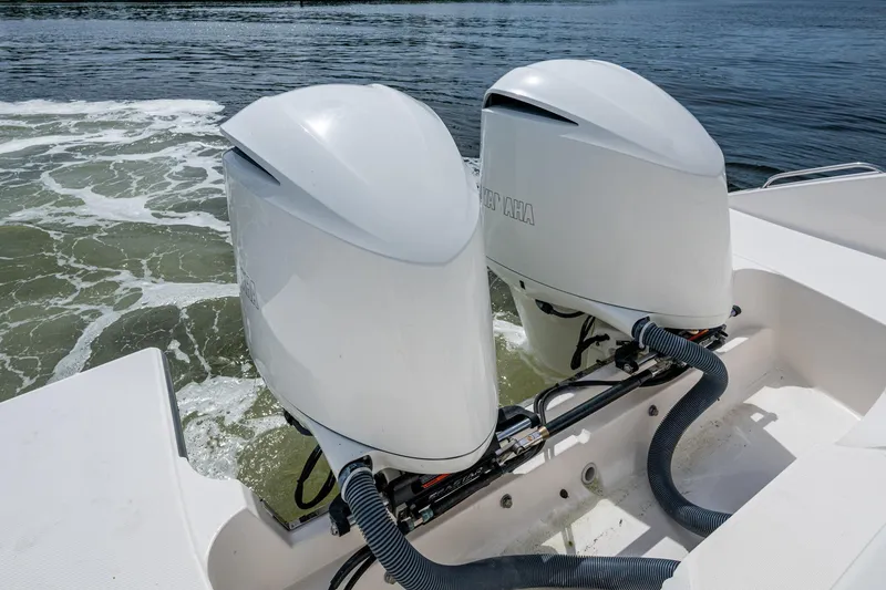 Slide: The Image of Twin outboard motors on a Pursuit boat, navigating through water. - 71