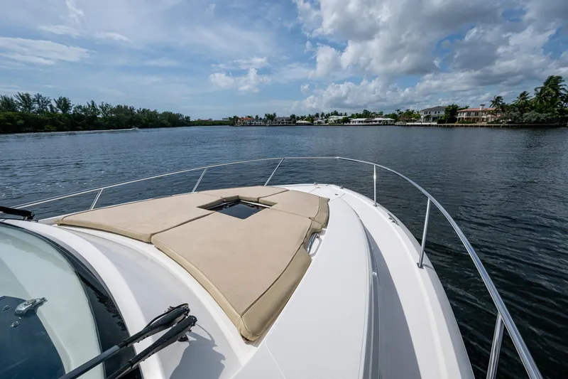Slide: The Image of Bow of a Pursuit boat on a calm river under a partly cloudy sky. - 76