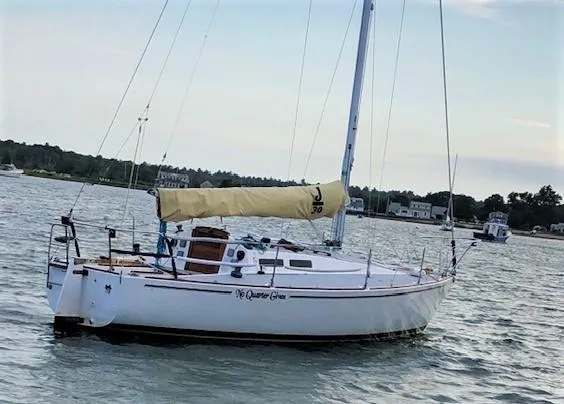 The Image of 1979 J Boats J 30 sailboat on calm water with yellow sail cover. - 1