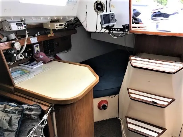 Slide: The Image of 1979 J Boats J 30 cabin interior with navigation station and seating area. - 10