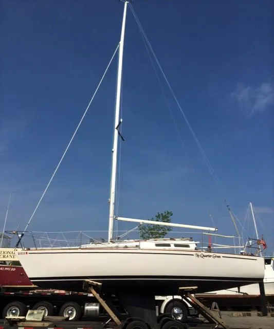 Slide: The Image of 1979 J Boats J 30 sailboat on trailer under clear blue sky. - 3