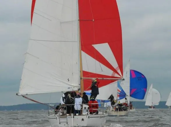 Slide: The Image of 1979 J Boats J 30 sailing with vibrant red and white sails on open water. - 5