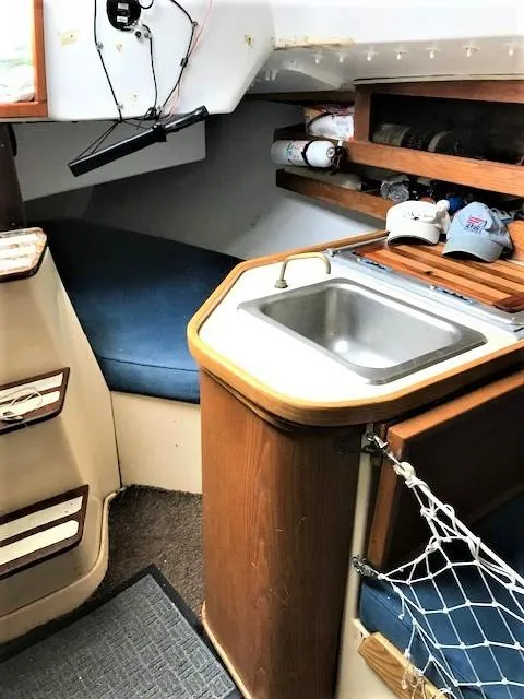 Slide: The Image of 1979 J Boats J 30 interior with sink, storage, and seating area. - 9