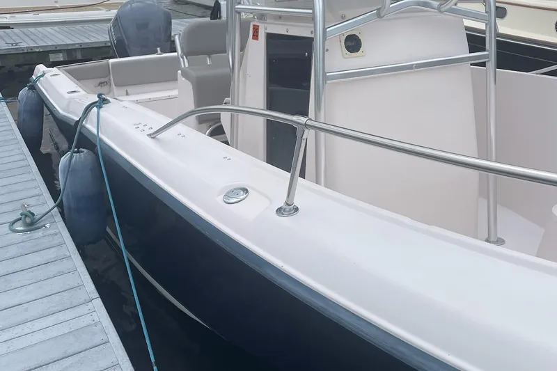 Slide: The Image of 2001 Grady-White Advance 247 boat docked, featuring sleek design and sturdy railings. - 5