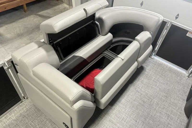 Slide: The Image of 2026 Sun Tracker PARTY BARGE® 20 DLX interior seating with storage compartments open. - 10