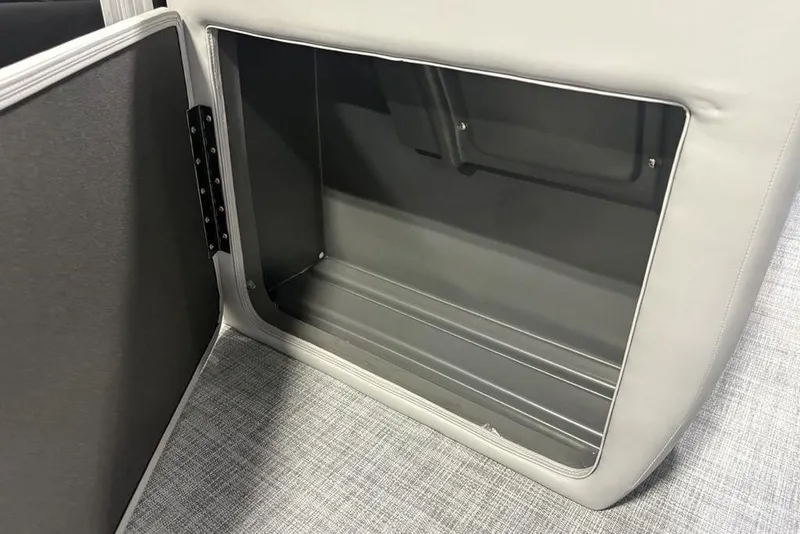 Slide: The Image of 2026 Sun Tracker PARTY BARGE® 20 DLX storage compartment with open door, gray interior. - 12