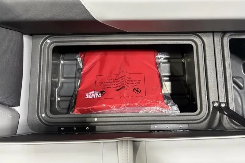 Slide: The Image of Storage compartment in 2026 Sun Tracker PARTY BARGE® 20 DLX with red life jacket. - 13