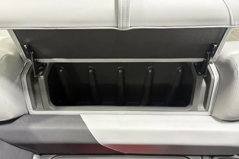 Slide: The Image of 2026 Sun Tracker PARTY BARGE® 20 DLX storage compartment with open lid and sleek design. - 15