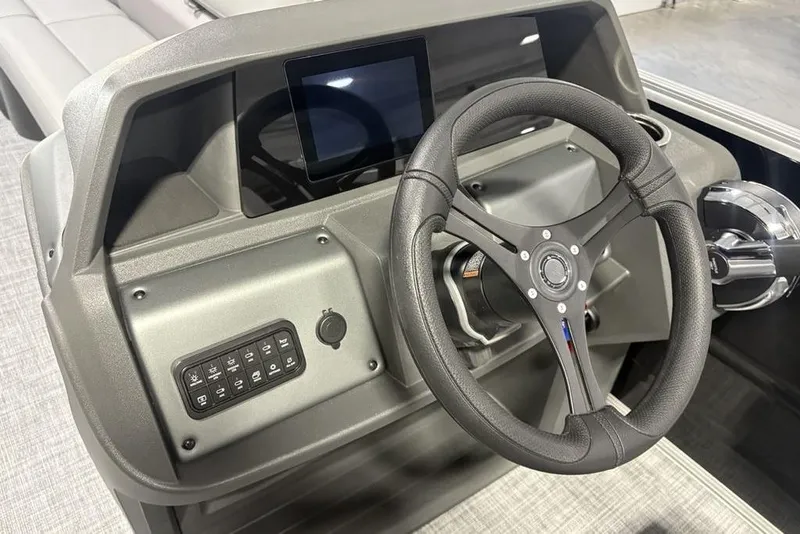 Slide: The Image of Steering console of 2026 Sun Tracker PARTY BARGE® 20 DLX with modern controls. - 19