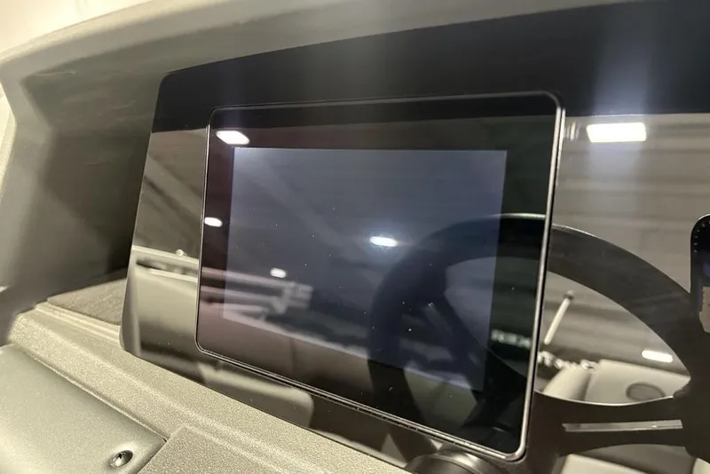 Slide: The Image of 2026 Sun Tracker PARTY BARGE® 20 DLX dashboard with touchscreen display. - 20