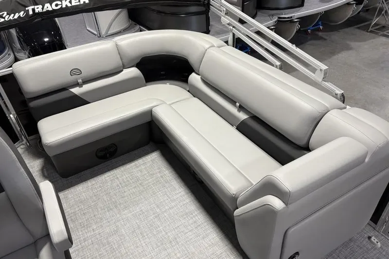 Slide: The Image of 2026 Sun Tracker PARTY BARGE® 20 DLX interior with plush gray seating. - 22