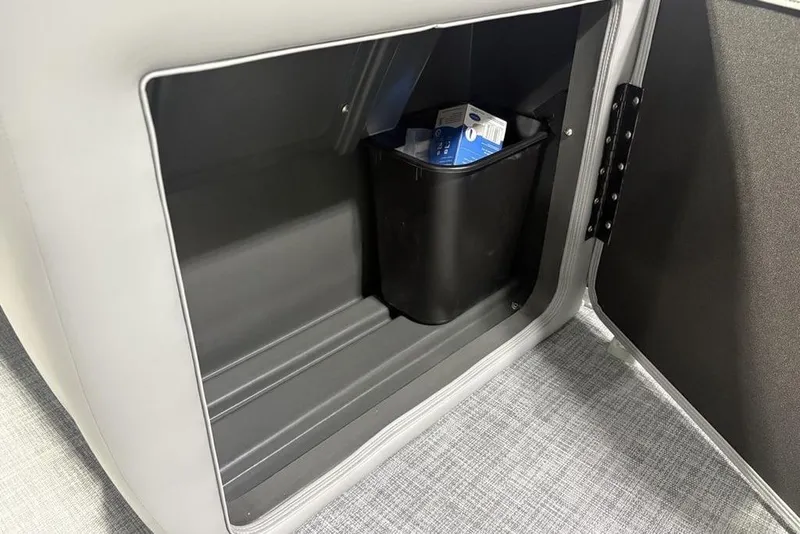 Slide: The Image of Storage compartment in 2026 Sun Tracker PARTY BARGE® 20 DLX with a black bin inside. - 24