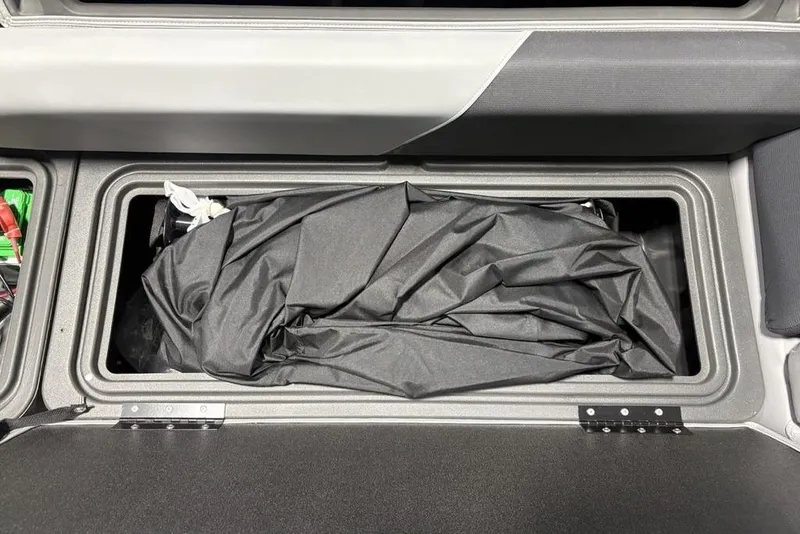 Slide: The Image of Storage compartment of 2026 Sun Tracker PARTY BARGE® 20 DLX with black cover inside. - 29