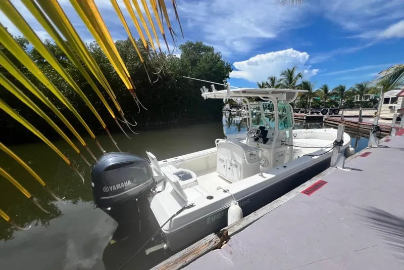 Slide: The Image of 2008 Everglades 243 Center Console boat docked by tropical foliage and clear blue sky. - 5