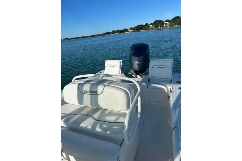 Slide: The Image of 2008 Everglades 243 Center Console boat on calm water, featuring seating and engine. - 7