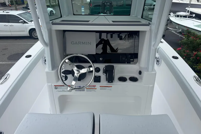 Slide: The Image of 2026 Blackfin 262 HB boat helm with Garmin navigation system and steering wheel. - 12