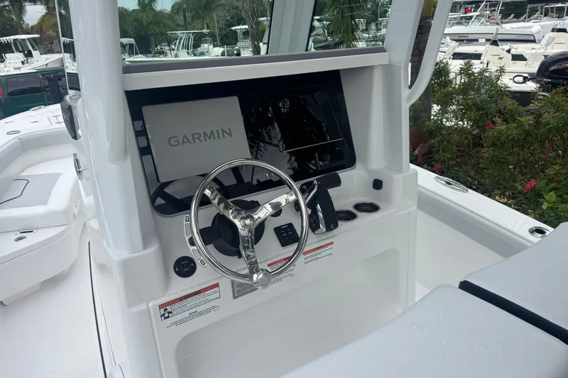 Slide: The Image of 2026 Blackfin 262 HB boat dashboard with Garmin navigation system and steering wheel. - 16