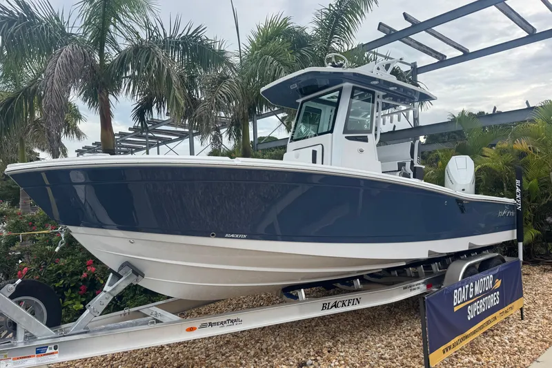 Slide: The Image of 2026 Blackfin 262 HB boat on trailer, surrounded by palm trees. - 2