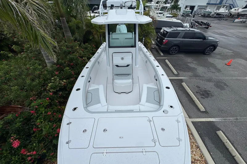 Slide: The Image of 2026 Blackfin 262 HB boat in parking lot, surrounded by greenery and vehicles. - 24