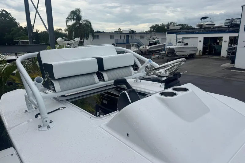 Slide: The Image of 2026 Blackfin 262 HB boat with sleek seating and steering wheel, docked at a marina. - 27