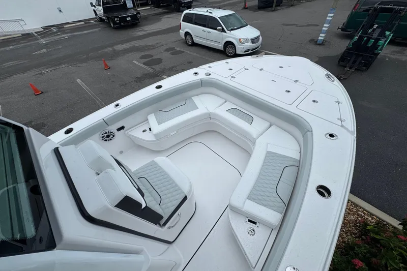 Slide: The Image of 2026 Blackfin 262 HB boat with spacious seating and modern design in a parking area. - 29