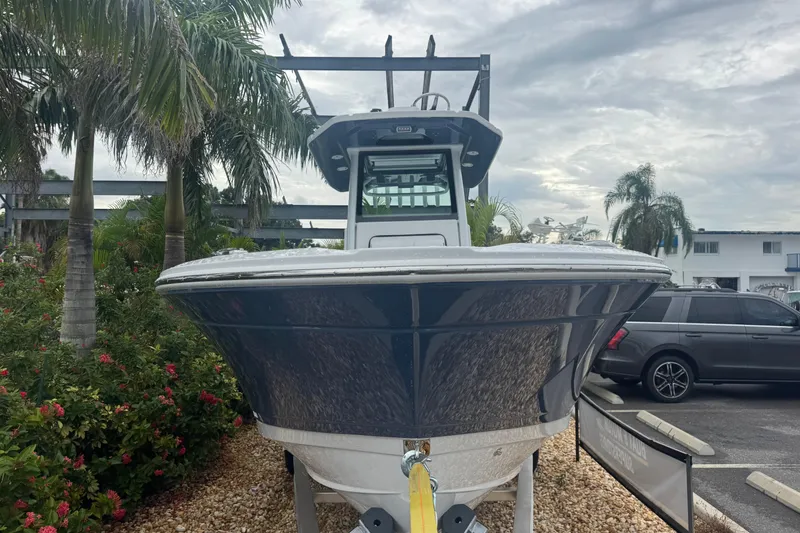 Slide: The Image of 2026 Blackfin 262 HB boat displayed outdoors with palm trees in the background. - 3