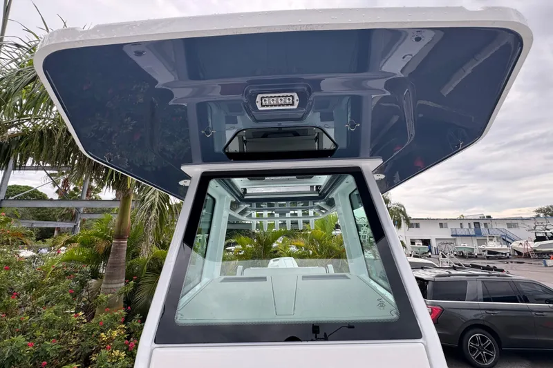 Slide: The Image of 2026 Blackfin 262 HB boat with sleek design, viewed from below the hardtop. - 34