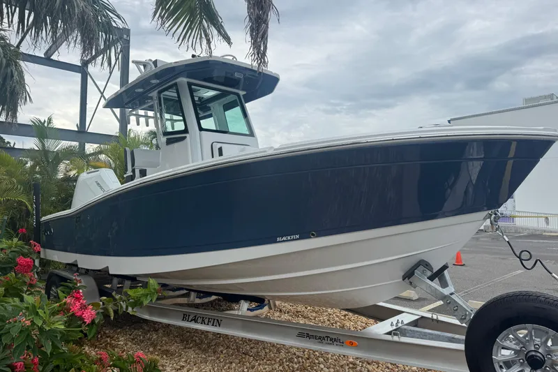 Slide: The Image of 2026 Blackfin 262 HB boat on trailer, surrounded by tropical plants. - 4