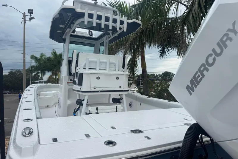Slide: The Image of 2026 Blackfin 262 HB boat with Mercury engine, parked near palm trees. - 6