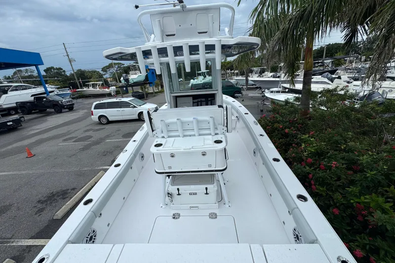 Slide: The Image of 2026 Blackfin 262 HB boat in marina, surrounded by vehicles and greenery. - 7