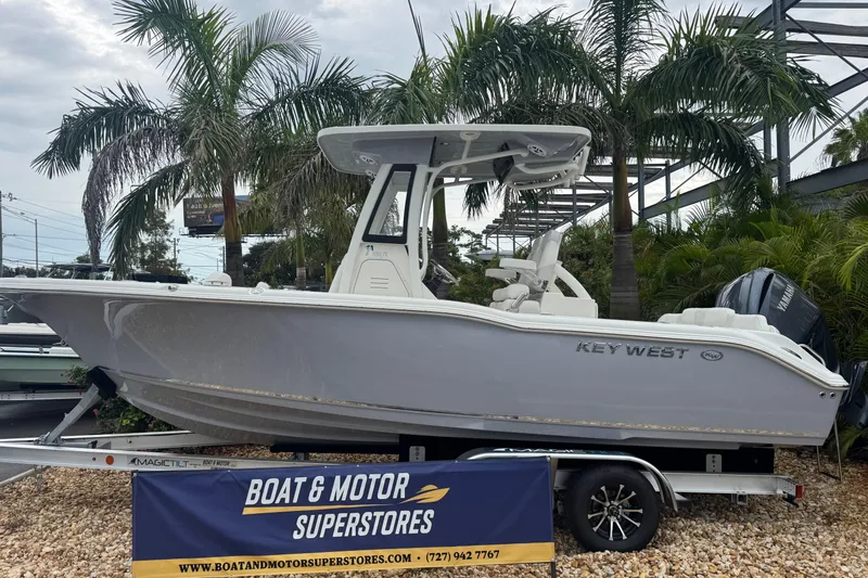 The Image of 2026 Key West 239 FS boat displayed at dealership with palm trees in background. - 0