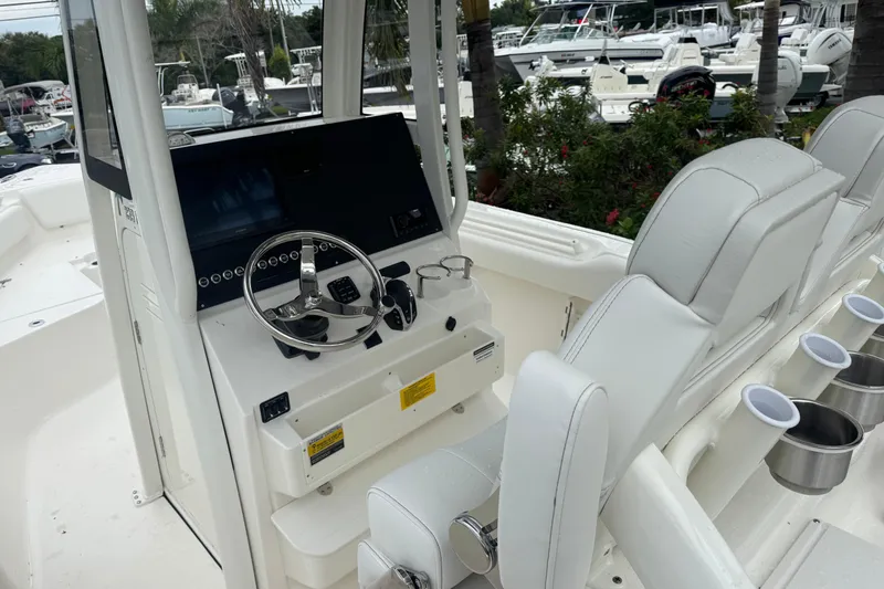 Slide: The Image of 2026 Key West 239 FS boat interior with steering console and seating. - 13