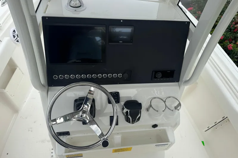 Slide: The Image of 2026 Key West 239 FS boat dashboard with steering wheel and control panel. - 16