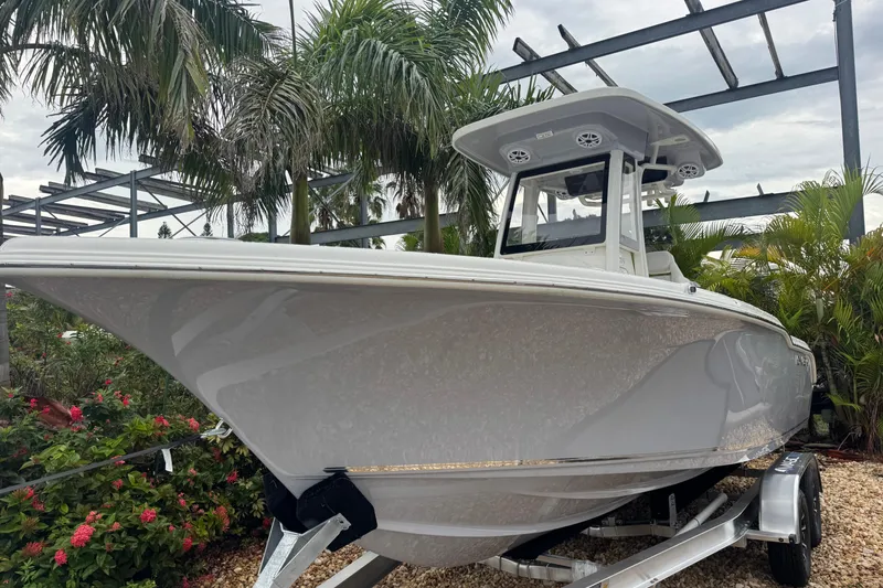 Slide: The Image of 2026 Key West 239 FS boat displayed outdoors with tropical plants. - 2