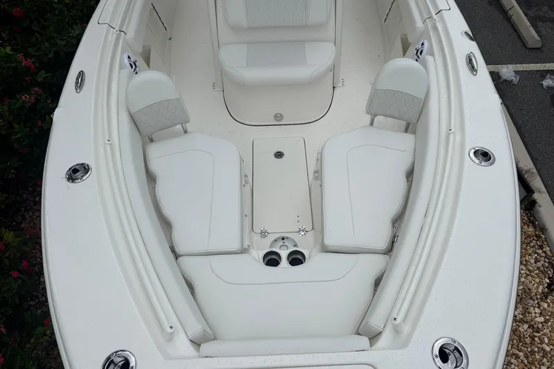 Slide: The Image of 2026 Key West 239 FS boat interior with white seating and cup holders. - 22