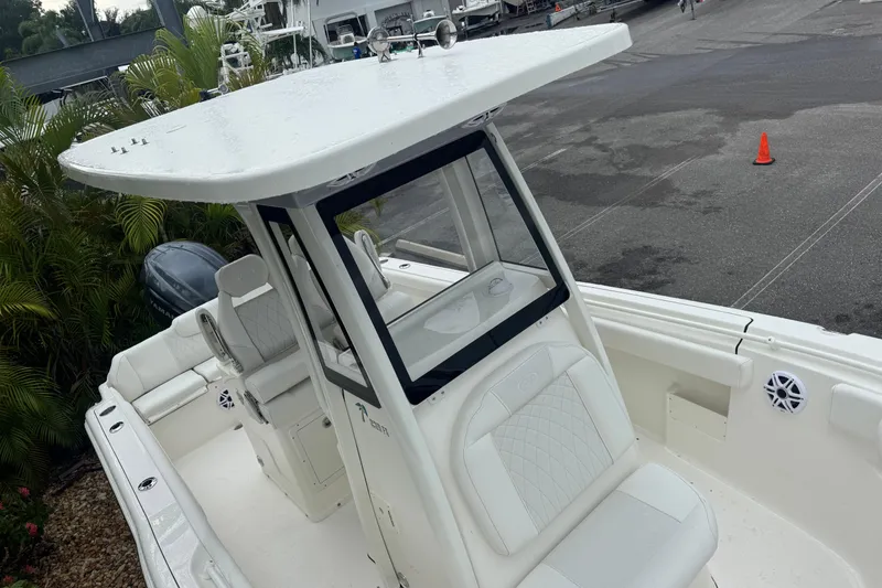 Slide: The Image of 2026 Key West 239 FS boat with T-top and seating, docked outdoors. - 25