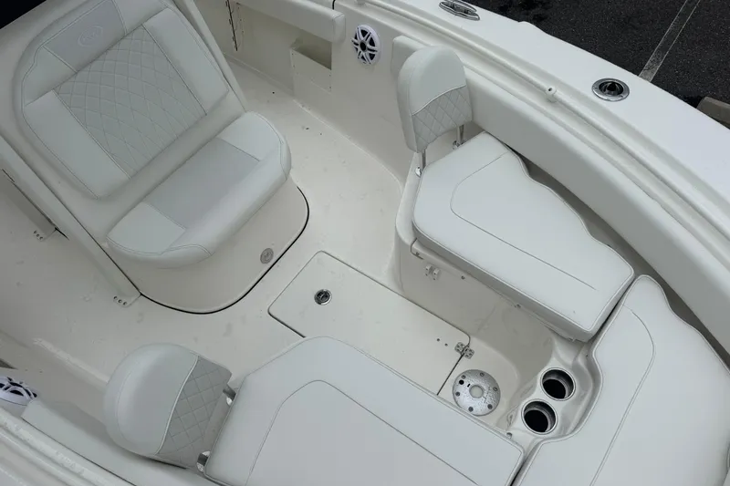 Slide: The Image of 2026 Key West 239 FS boat interior with white cushioned seating and cup holders. - 26