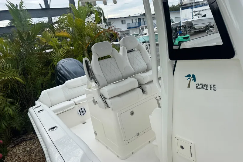 Slide: The Image of 2026 Key West 239 FS boat interior with white seating and Yamaha engine. - 29