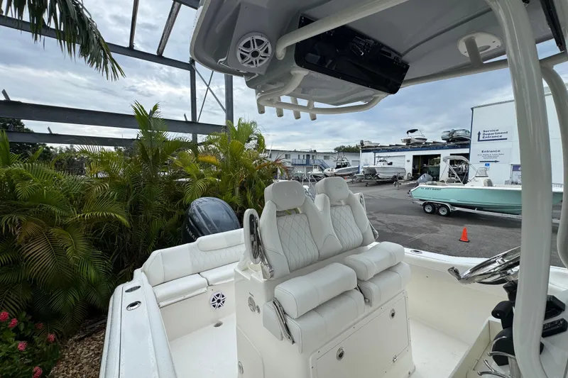 Slide: The Image of 2026 Key West 239 FS boat interior with white seating and steering console. - 33
