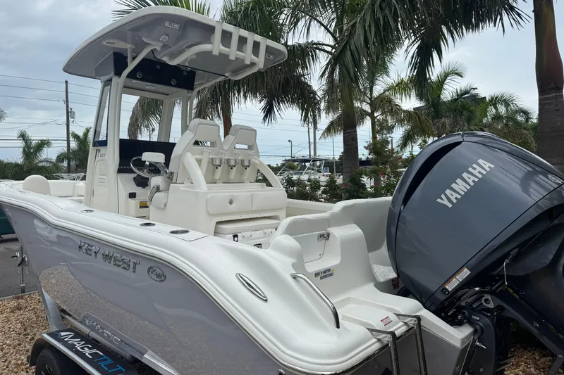 Slide: The Image of 2026 Key West 239 FS boat with Yamaha engine, parked near palm trees. - 5