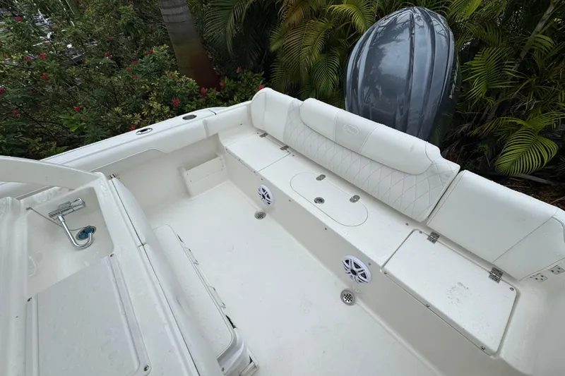 Slide: The Image of 2026 Key West 239 FS boat interior with white seating and storage compartments. - 7