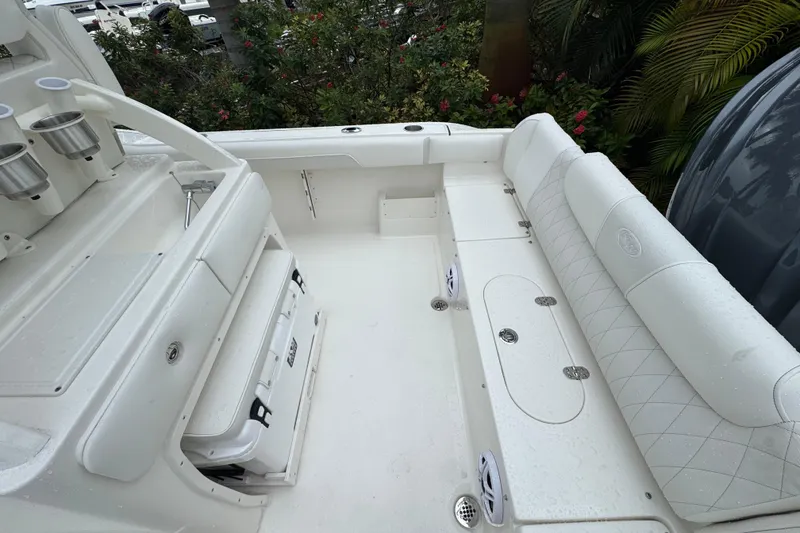 Slide: The Image of 2026 Key West 239 FS boat interior with white seating and storage compartments. - 8