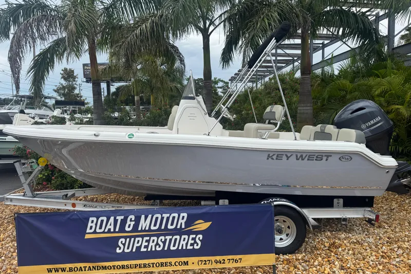 The Image of 2026 Key West 189 FS boat displayed at Boat & Motor Superstores, surrounded by palm trees. - 1