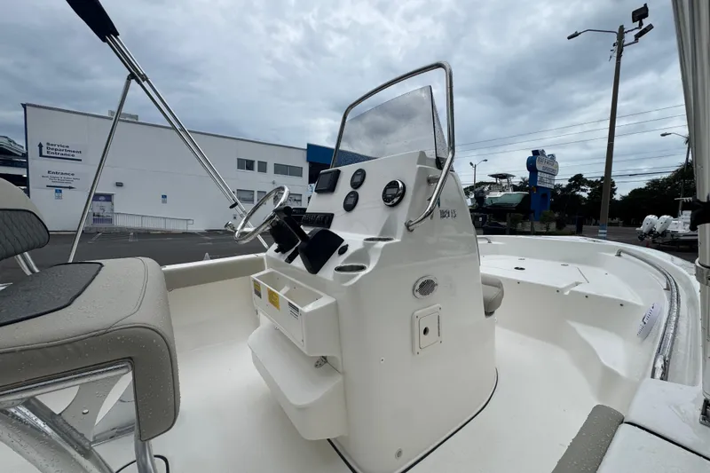Slide: The Image of 2026 Key West 189 FS boat interior with steering console and seating. - 11