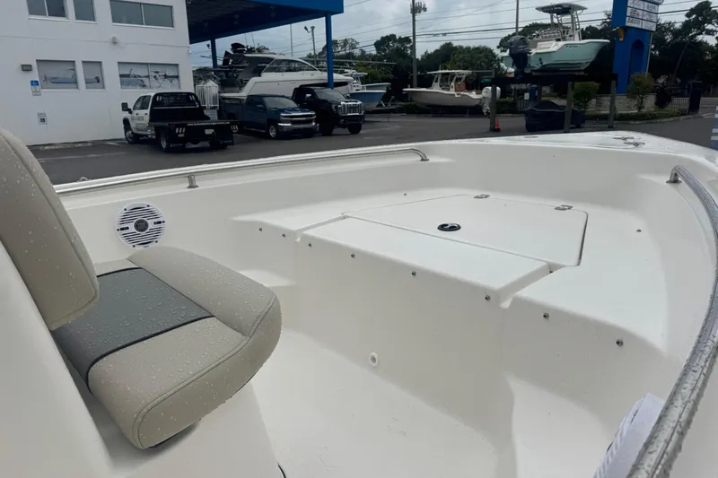 Slide: The Image of 2026 Key West 189 FS boat interior with seating and storage, parked at a marina. - 13