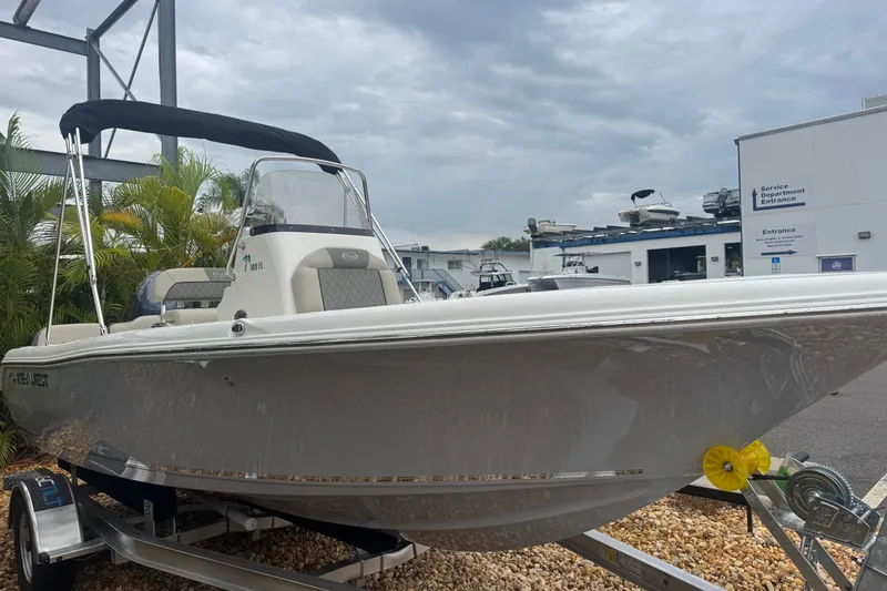 Slide: The Image of 2026 Key West 189 FS boat on trailer, parked near service department, under cloudy sky. - 14