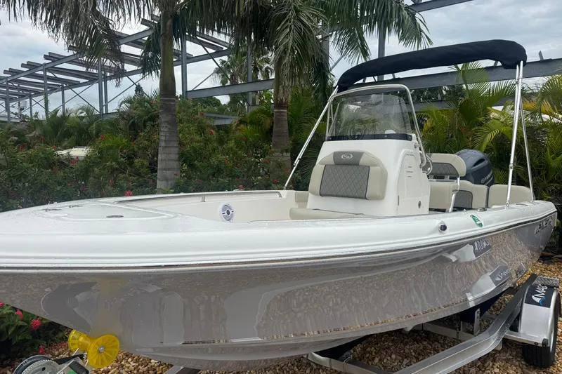 Slide: The Image of 2026 Key West 189 FS boat with canopy, parked outdoors among palm trees. - 16