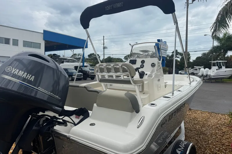 Slide: The Image of 2026 Key West 189 FS boat with Yamaha engine, parked outdoors near dealership. - 4