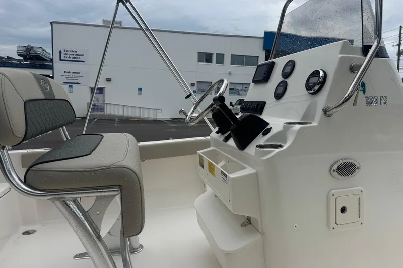 Slide: The Image of 2026 Key West 189 FS boat interior with steering console and seating. - 8
