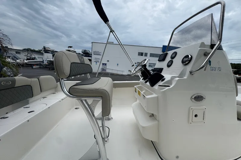 Slide: The Image of 2026 Key West 189 FS boat interior with steering console and seating. - 9